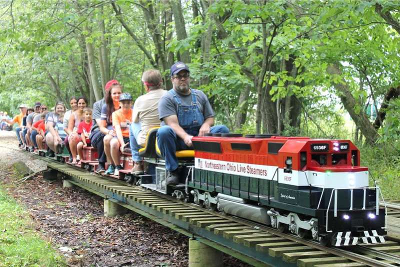 Ride the rails - picture of kids and adults riding a small motorized train