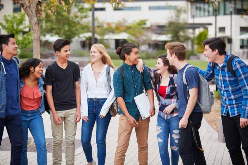 Teen Social Club – Group of teens talking and laughing Teen Social Club - Group of teens talking and laughing