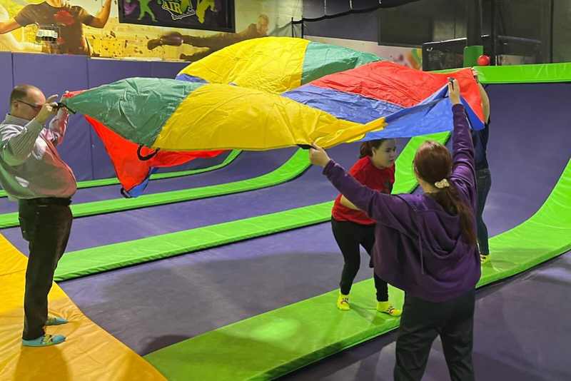 Jump With ASGA At Get Air Akron - kids and adult jumping with parachute