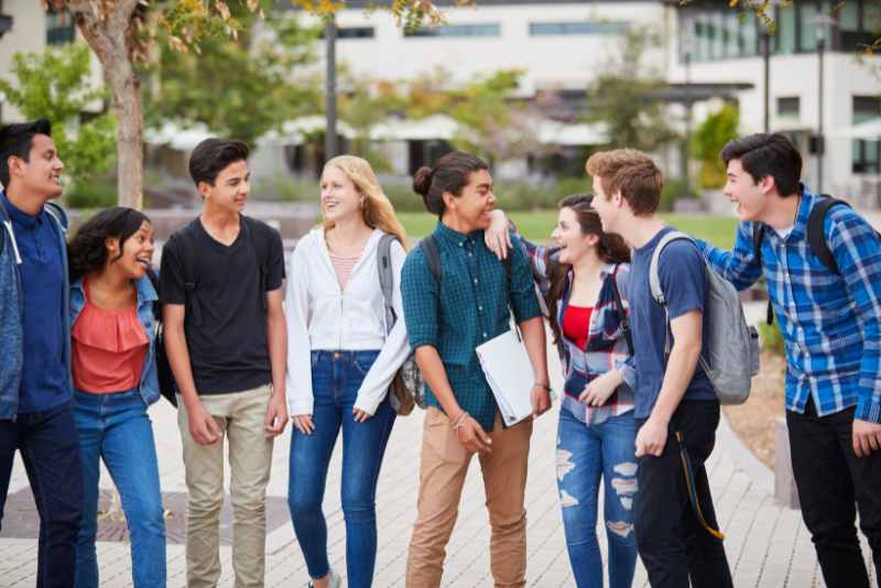 Teen Social Club - Group of teens talking and laughing