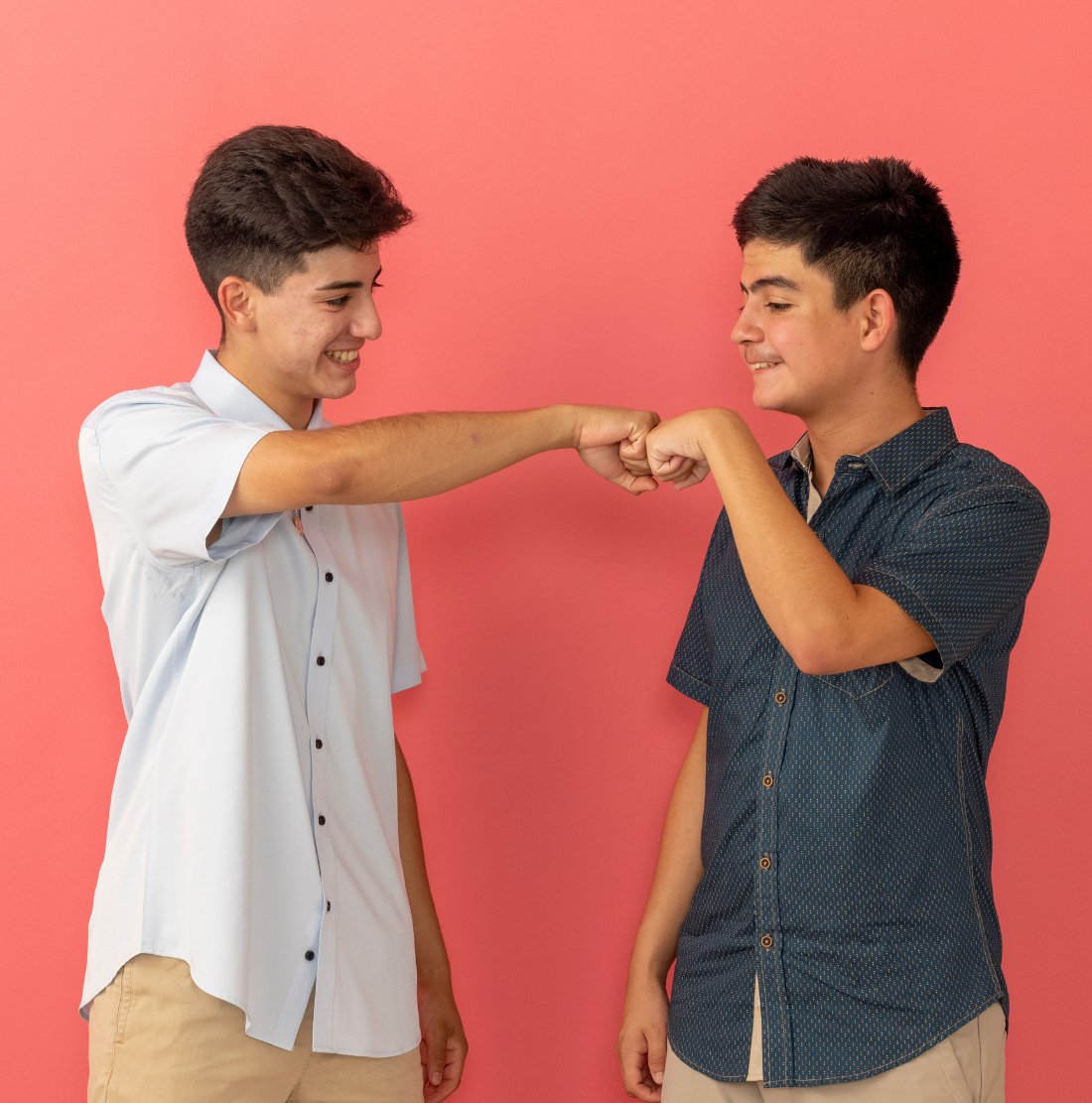 Two young men giving each other a fist bump