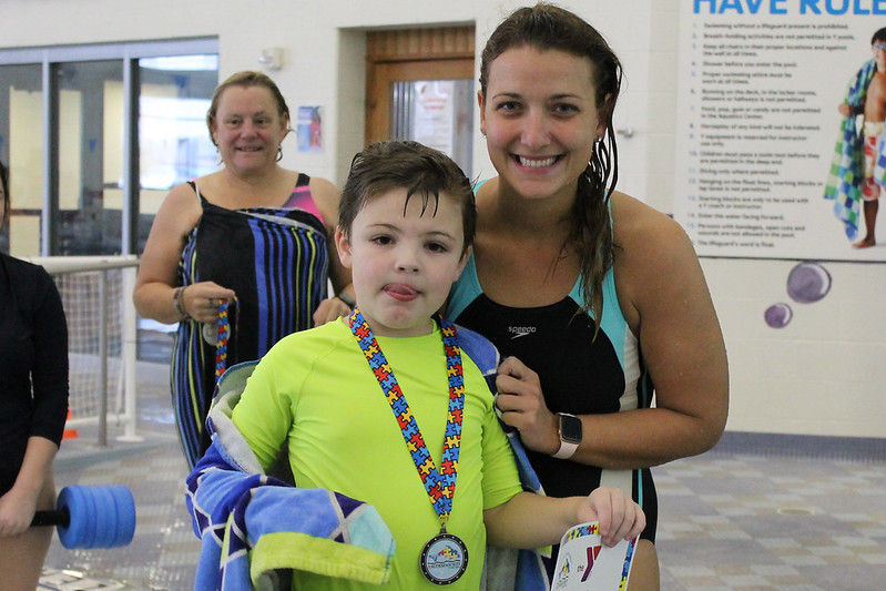 Proud child earning his swimming award.