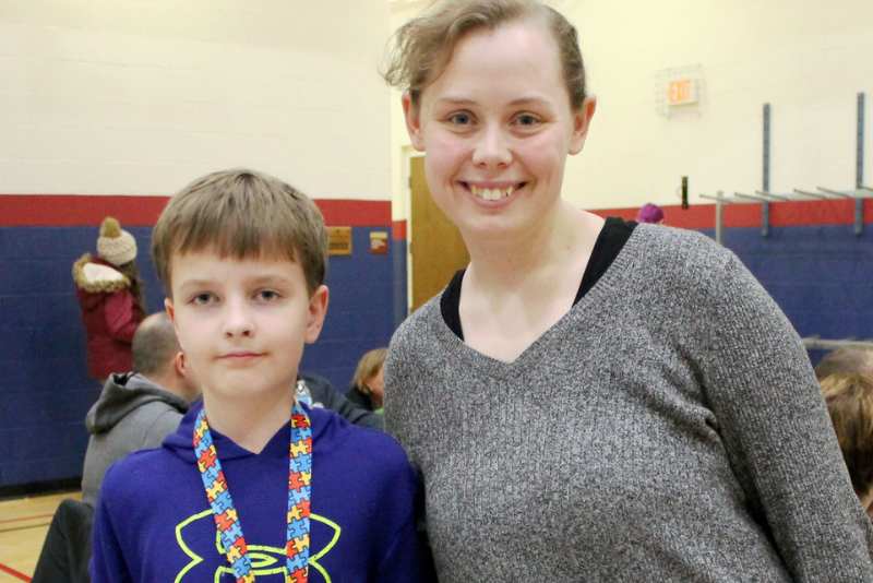 Young boy smiling with teacher